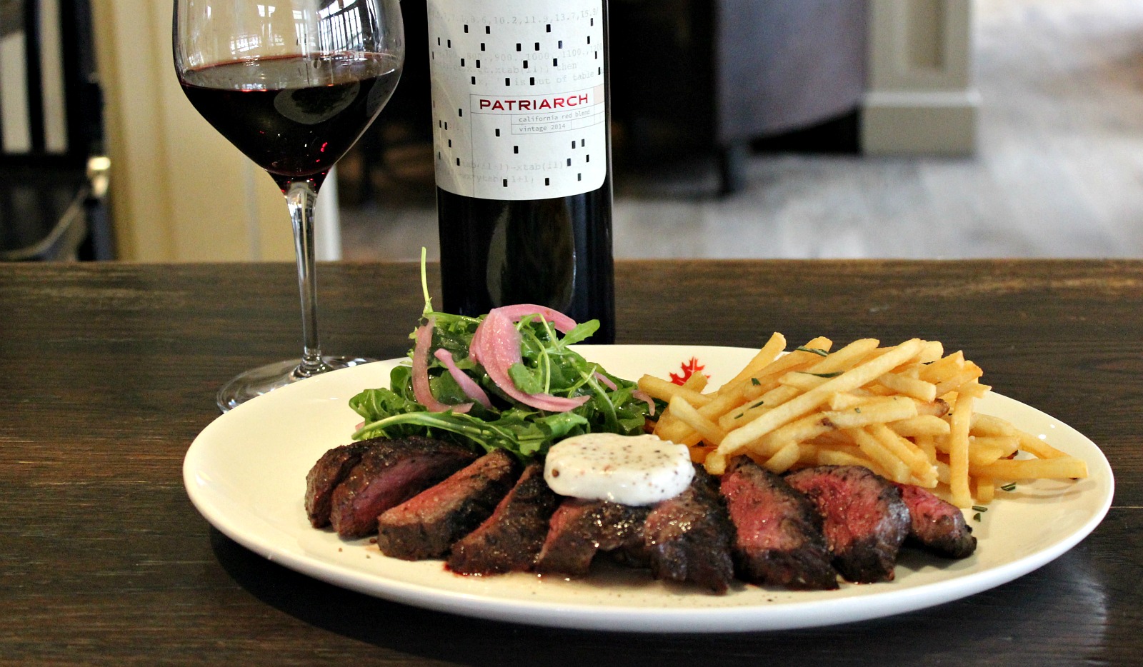 Steak frites with Patriarch red wine in the background
